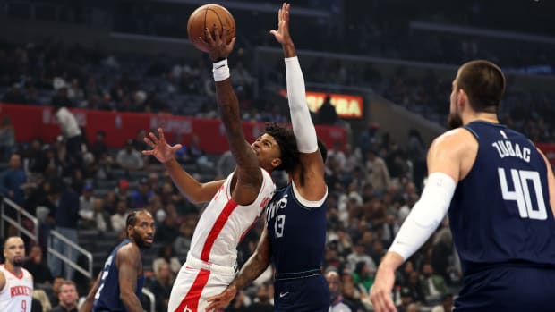 Houston Rockets guard Jalen Green shoots the ball past L.A. Clippers forward Paul George during the first quarter at Crypto.com Arena.